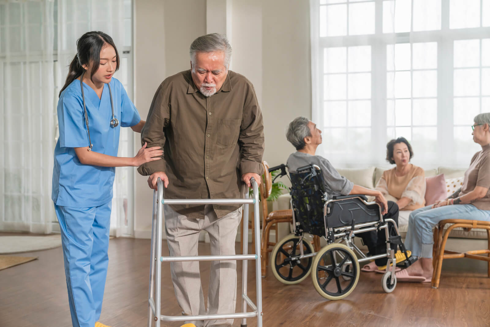 young-asian-female-nurse-care-giver-helping-asian-senior-old-man-with-mobility-walker-living-area-nursing-home-senior-daycare-centernurse-take-care-elderly-patient-with-cheerful-concentrate